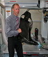 simon farren | reverie | models prototypes – Reverie MD Simon Farren with completed Racing Seat in front of new 5-axis machine